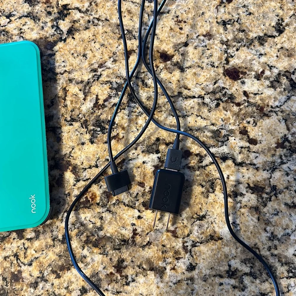 Nook reader with green case and charger cord
